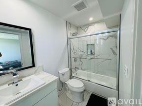 Los Angeles apartment for rent - A bathroom with a toilet, sink, and mirror.