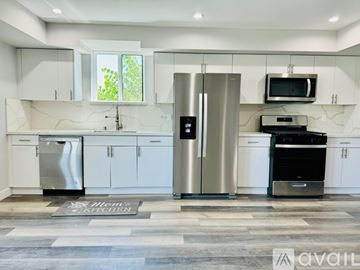 Los Angeles apartment for rent - A modern kitchen with stainless steel appliances and white cabinets.