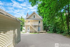 Huntington apartment for rent - A house with a driveway and trees in the background.