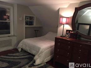 Huntington apartment for rent - A bedroom with a bed, dresser, and mirror.