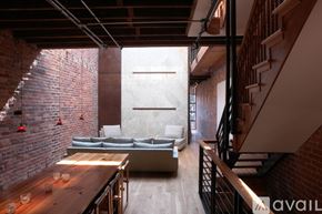 Washington townhouse for rent - A living room with a brick wall and a couch.
