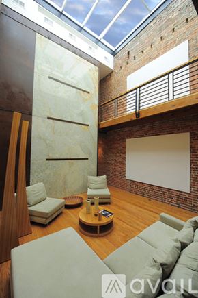 Washington townhouse for rent - A living room with a glass ceiling and a wooden floor.