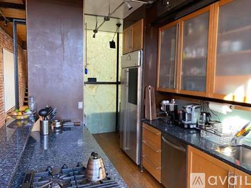 Washington townhouse for rent - A kitchen with a stove top oven and a refrigerator.