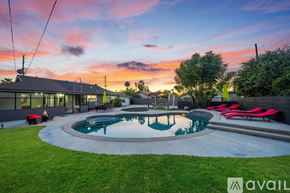 Los Angeles house for rent - A backyard with a pool and a house with a balcony.