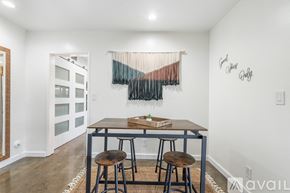 Los Angeles house for rent - A dining room with a wooden table and two chairs.