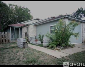 Austin townhouse for rent - A purple door is on the right and a window is on the left.