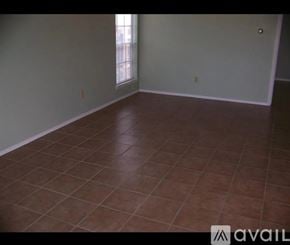 Austin townhouse for rent - A room with brown tiled flooring and a window.