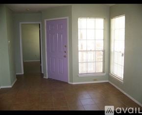 Austin townhouse for rent - A room with a purple door and brown tile flooring.