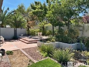 Las Vegas house for rent - A living room with a couch, chair, and table.