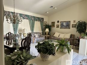 Las Vegas house for rent - A dining room with a wooden table and chairs.