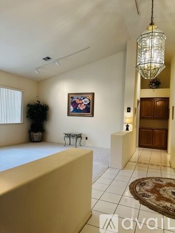Las Vegas house for rent - A living room with a painting on the wall and a rug on the floor.