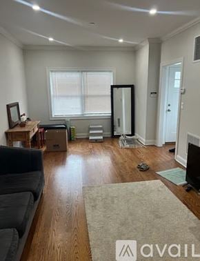 Harrison townhouse for rent - A living room with a couch, a rug, and a television.
