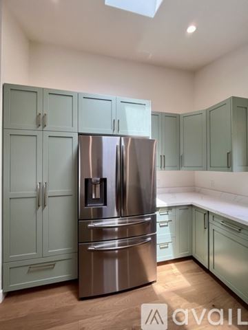 Eureka house for rent - A kitchen with a stainless steel refrigerator and cabinets.