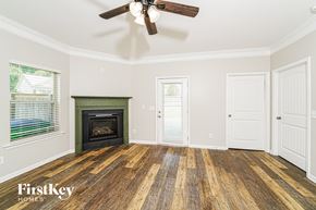 Leeds house for rent - A room with a wood floor and a fireplace.