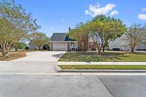 Jacksonville house for rent - A house with a driveway and trees in front.