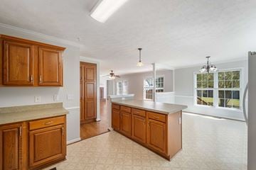 Jacksonville house for rent - A kitchen with wooden cabinets and a countertop.