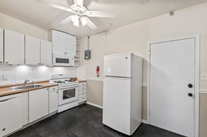 Denver apartment for rent - A white kitchen with a refrigerator, oven, and microwave.