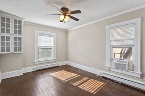 Denver apartment for rent - A room with a ceiling fan and two windows.