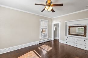 Denver apartment for rent - A room with a ceiling fan and a wooden floor.