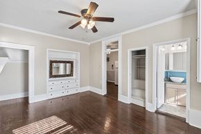 Denver apartment for rent - A room with a ceiling fan and a dresser with a mirror.