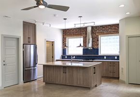 Denver apartment for rent - A modern kitchen with a large island and a stainless steel refrigerator.