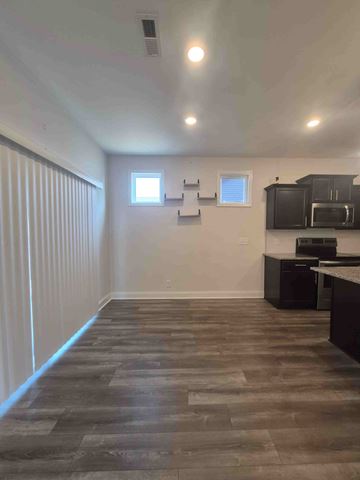 Clarksville house for rent - A kitchen with a black counter top and a microwave.