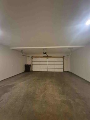 Clarksville house for rent - A large empty room with a concrete floor and white walls.
