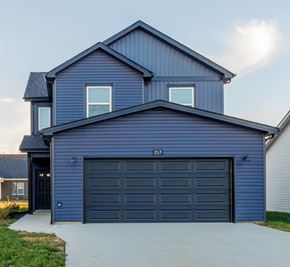 Clarksville house for rent - A blue house with a black garage door and the number 217 on it.