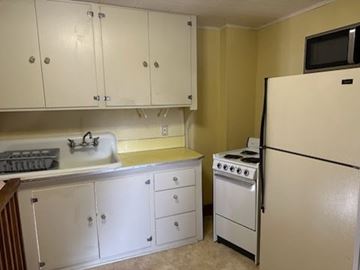 Stevens Point apartment for rent - A kitchen with white cabinets and a white fridge.