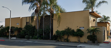 Fullerton apartment for rent - A yellow building with a red street sign in front of it.
