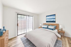 Riverside apartment for rent - A bedroom with a large bed and a painting on the wall.