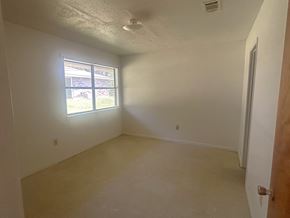 Woodville apartment for rent - A room with a window and a door.
