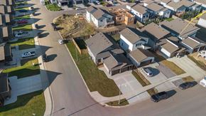 Grande Prairie apartment for rent - A residential area with houses and cars.
