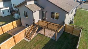Grande Prairie apartment for rent - A house with a deck and a brown fence.