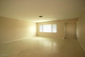 Cocoa house for rent - A large empty room with a window on the wall.