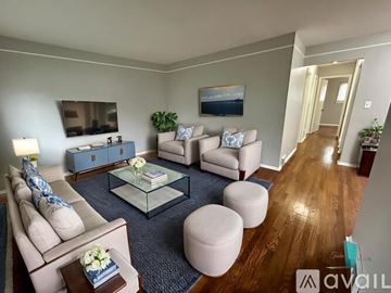 Detroit house for rent - A living room with a glass coffee table and a blue rug.