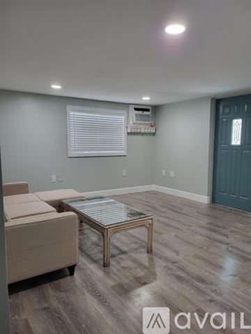 Stock Island apartment for rent - A living room with a beige couch and a glass coffee table.