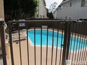 Culver City apartment for rent - A pool surrounded by a black fence.