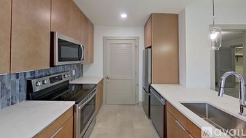 Huntington apartment for rent - A kitchen with wooden cabinets and a white countertop.