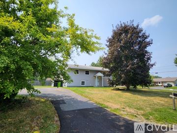 Baldwinsville house for rent - A kitchen with white cabinets and a stainless steel refrigerator.