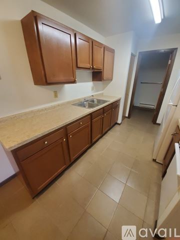 La Crosse apartment for rent - A kitchen with brown cabinets and a countertop.