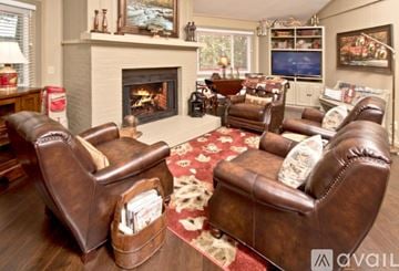 Sky Valley house for rent - A living room with brown leather chairs and a fireplace.