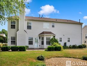 Suwanee house for rent - A two-story house with a front yard and a small garden.