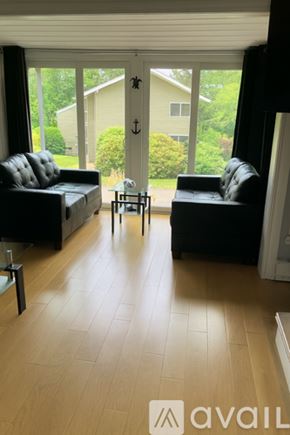 Laconia townhouse for rent - A kitchen with a wooden table and chairs in front of a welcome sign.