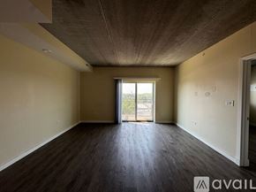 Chicago apartment for rent - A spacious room with wooden floors and a slanted ceiling.