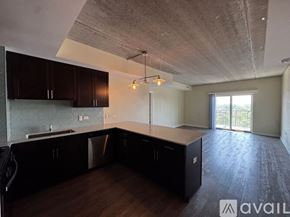 Chicago apartment for rent - A kitchen with dark wood cabinets and a concrete ceiling.