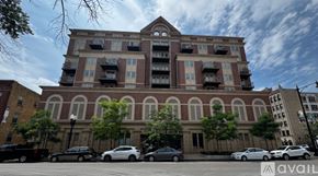 Chicago apartment for rent - A large building with a parking lot in front of it.