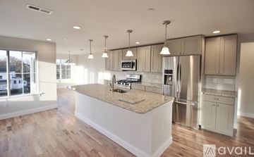 Oxford apartment for rent - A modern kitchen with a granite countertop and stainless steel appliances.