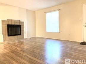 Richmond apartment for rent - A room with a wooden floor, a window, and a door.