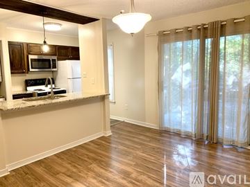 Richmond apartment for rent - A kitchen with wooden cabinets and a granite countertop.